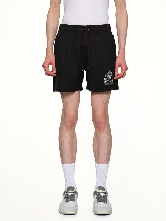 Image of a model wearing Shorts. Productname: AMIRI MA Crest Swim Trunk in BLACK colour by brand - AMIRI