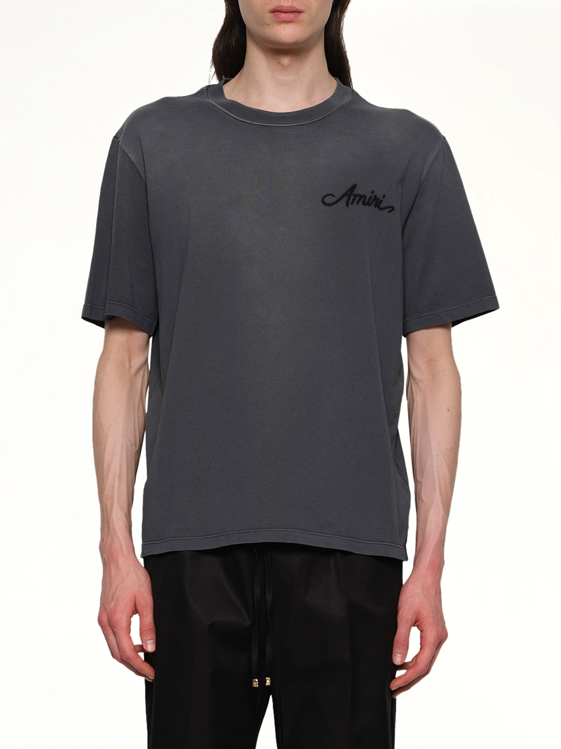 Image of a model wearing Tops. Productname: AMIRI Bleach Bandana Patch T-Shirt in BLACK colour by brand - AMIRI