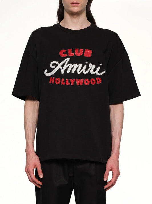 Image of a model wearing Tops. Productname: AMIRI Club Amiri Overzied Tee in BLACK colour by brand - AMIRI