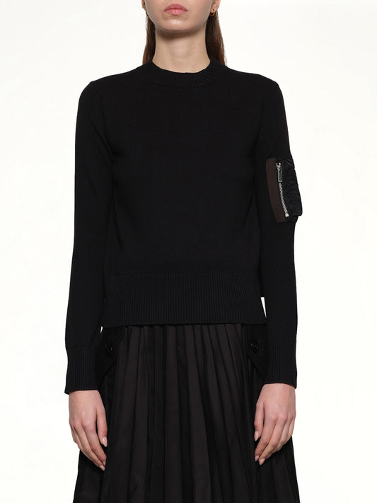 Image of a model wearing Outerwear. Productname: SACAI Nylon Twill x Cotton Knit Pullover in Black colour by brand - SACAI