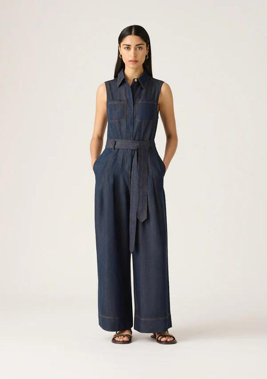 Image of a model wearing Outerwear. Productname: Cleo Denim Jumpsuit in Indigo colour by brand - MOS The Label