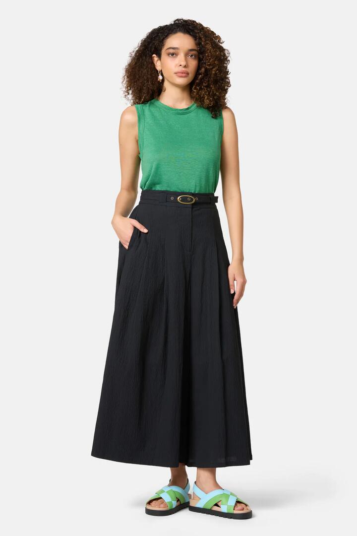 Image of a model wearing Skirts. Product name - Pucker Up Cotton Skort in Black colour by brand - Gorman