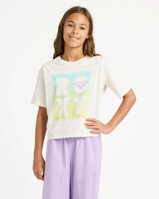 Image of a model wearing Tops. Productname: roxy Girls 4-16 Daisyloose Beach T-Shirt Coconut Milk - in Coconut Milk colour by brand - Roxy