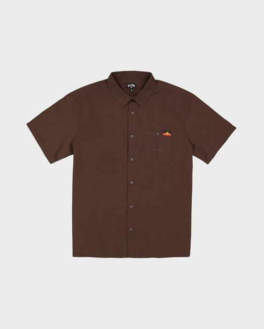 Image of a model wearing Tops. Productname: billabong Mens Otis Flag Short Sleeve Shirt Chocolate - in Chocolate colour by brand - Billabong