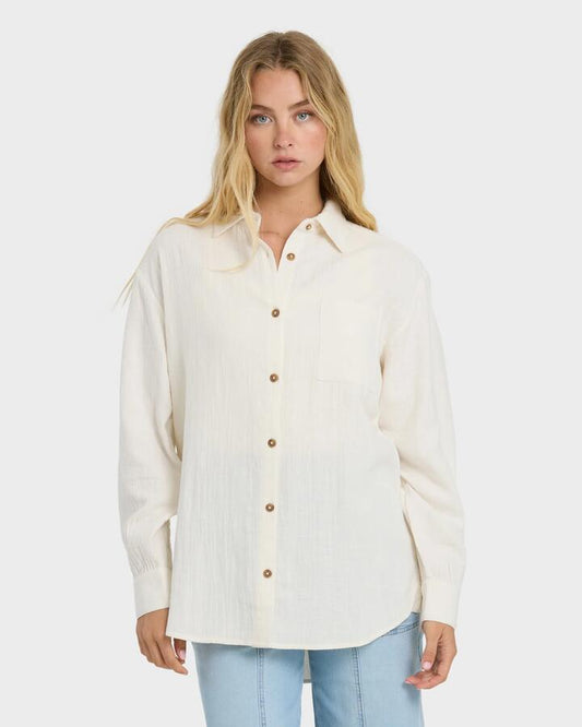 Image of a model wearing Tops. Product name - Billabong Womens Wanderer Long Sleeve Button-Down Shirt Salt Crystal in Salt Crystal colour by brand - Billabong