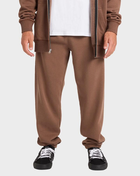 Image of a model wearing Pants. Product name - Billabong Mens Premium Wave Wash Trackpants Mocha in Mocha colour by brand - Billabong
