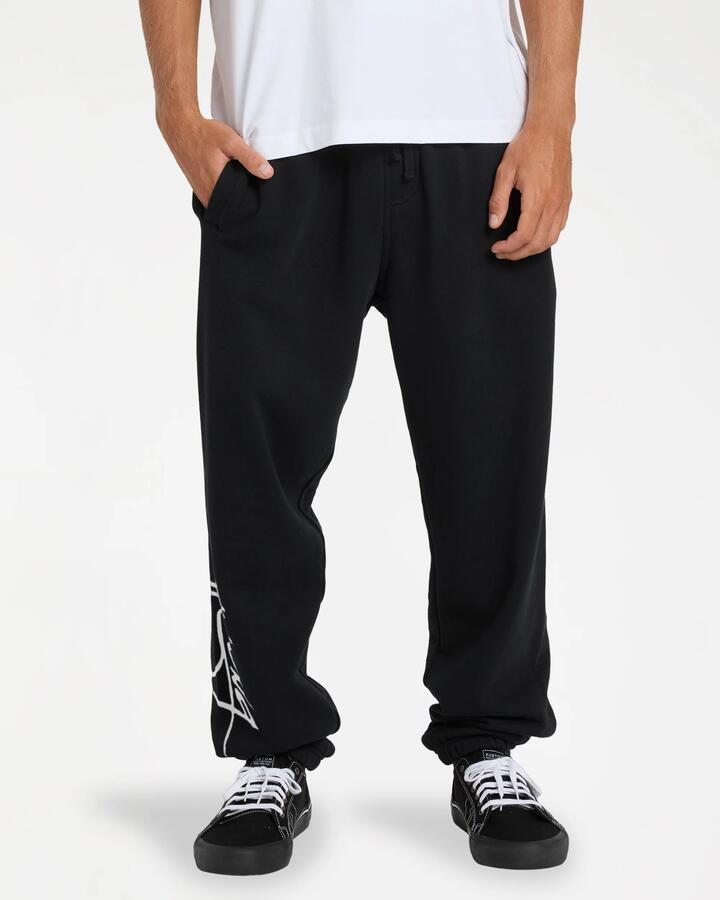 Image of a model wearing Pants. Product name - Billabong Mens Jbay Trackpants Black in Black colour by brand - Billabong
