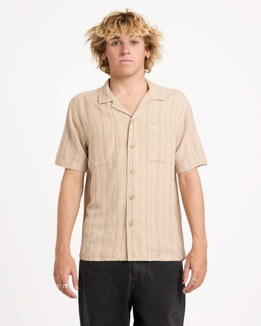 Image of a model wearing Tops. Productname: rvca Mens Exotica Stripe Short Sleeve Shirt Light Khaki - in Light Khaki colour by brand - Rvca