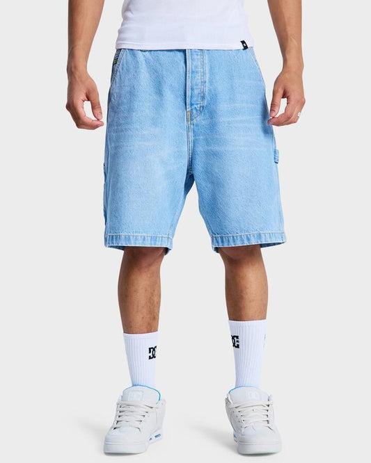 Image of a model wearing Shorts. Productname: DC Shoes - Mens Baggy Denim Carpenter Shorts - Indigo Light - in Indigo Light colour by brand - DC Shoes