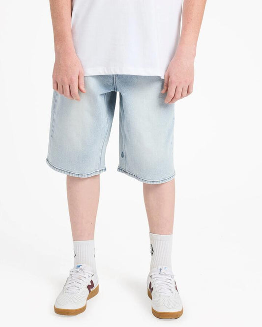 Image of a model wearing Shorts. Product name - Volcom Boys 8-16 Billow Denim Shorts Desert Dirt Indigo in Desert Dirt Indigo colour by brand - Volcom
