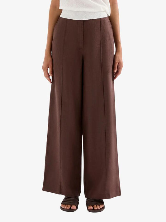 Image of a model wearing Pants. Productname: Nude Lucy Theo Linen Pants in Chocolate colour by brand - Nude Lucy
