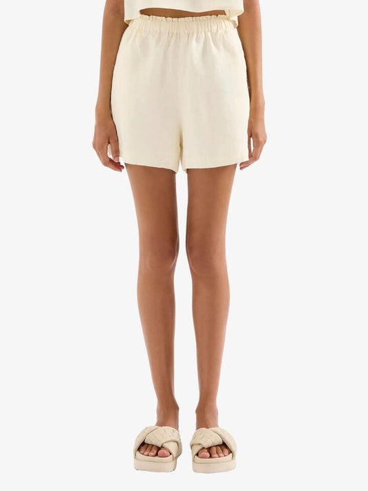Image of a model wearing Shorts. Productname: Nude Lucy Theo Linen Shorts in Chamomile colour by brand - Nude Lucy