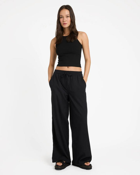 Image of a model wearing Pants. Product name - Volcom Womens Dropping In Pants Black in Black colour by brand - Volcom