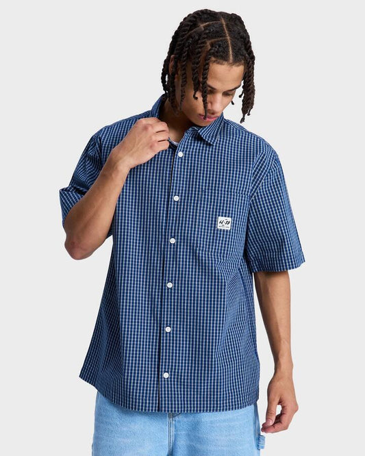 Image of a model wearing Tops. Productname: DC Shoes - Mens Game On Short Sleeve Shirt - Estate Blue - in Estate Blue colour by brand - DC Shoes