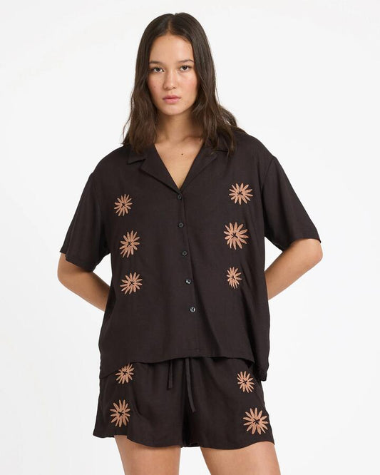 Image of a model wearing Tops. Productname: volcom - Womens Florez Ii Short Sleeve Shirt - Vintage Black - in Vintage Black colour by brand - volcom