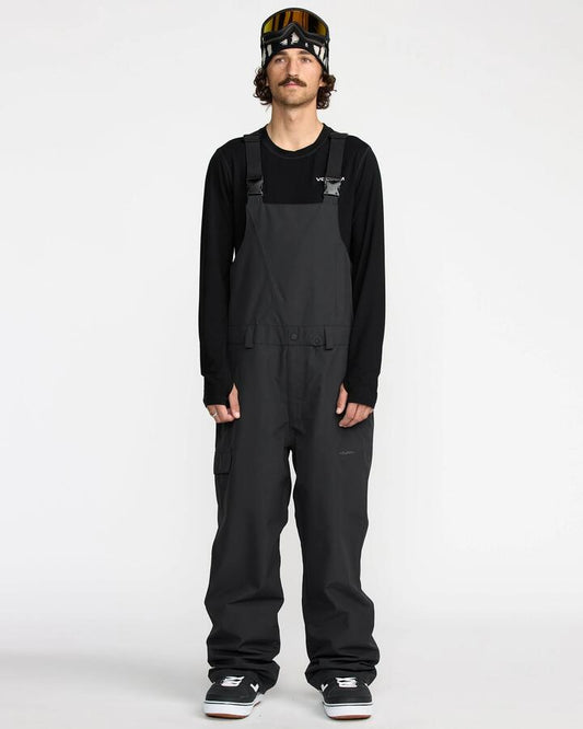 Image of a model wearing Pants. Productname: Volcom - Mens V.Co Sparta Bib Snow Pants - Black - in Black colour by brand - Volcom