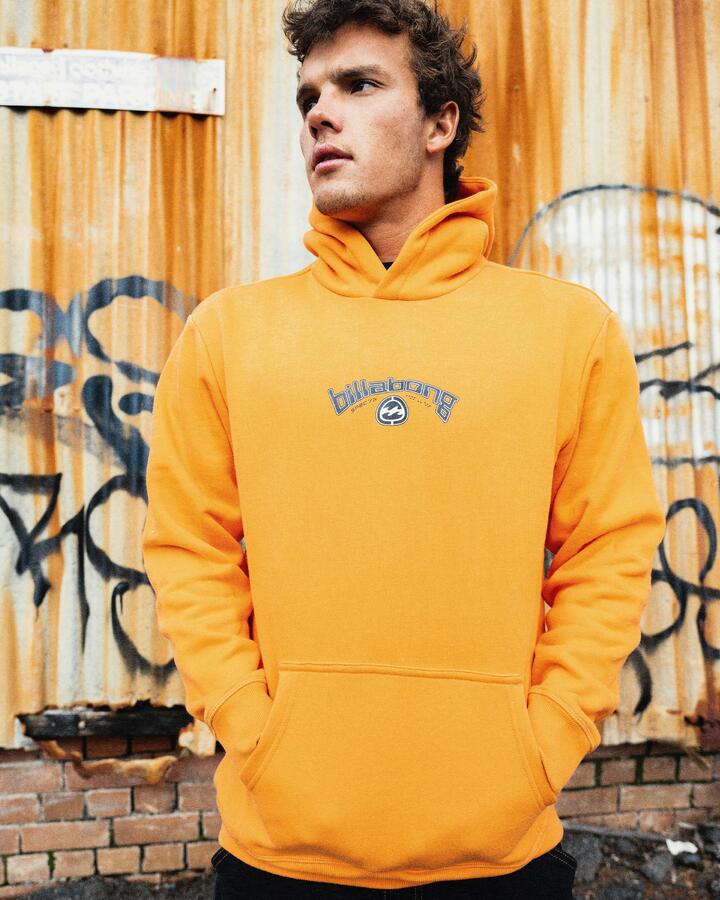 Image of a model wearing Outerwear. Product name - Billabong Mens Spec Bio Arch Pullover Hoodie Dusty Orange in Dusty Orange colour by brand - Billabong
