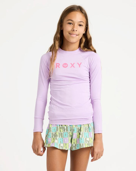 Image of a model wearing Tops. Product name - Roxy Girls 6-16 Essentials Long Sleeve Lycra Rash Vest Crocus Petal in Crocus Petal colour by brand - Roxy