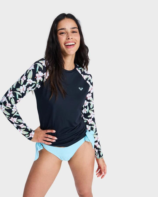 Image of a model wearing Tops. Productname: roxy - Womens Lycra Long Sleeve Rash Vest - Anthracite Spring Charming Sma - in Anthracite Spring Charming Sma colour by brand - roxy