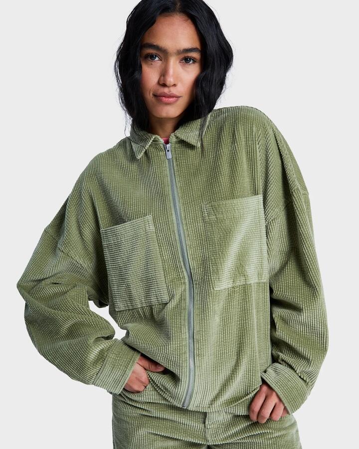 Image of a model wearing Tops. Productname: roxy - Womens Chilled Out Washed Cord Long Sleeve Shirt - Oil Green - in Oil Green colour by brand - roxy