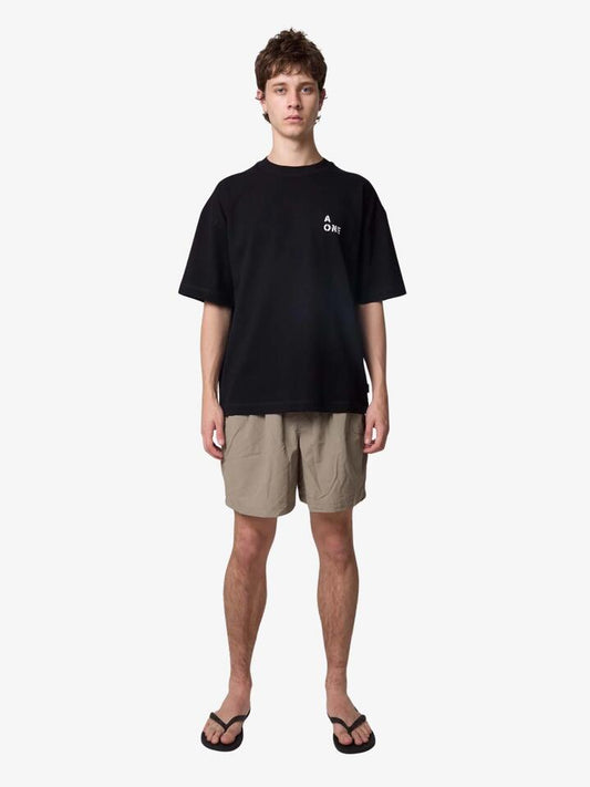 Image of a model wearing Tops. Productname: Article One Nowhere Fast Tee in Black colour by brand - Article One