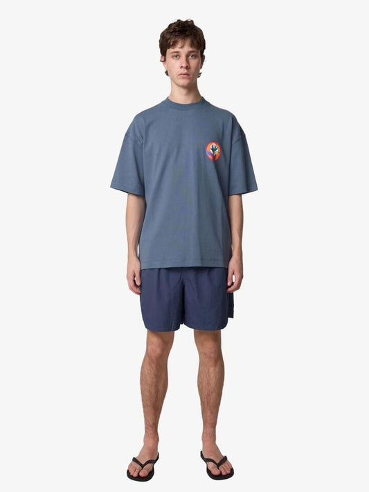 Image of a model wearing Tops. Productname: Article One Tropical Deco Tee in Steel Blue colour by brand - Article One