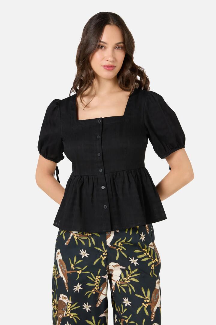 Image of a model wearing Tops. Productname: Eveleigh Peplum Top in Black colour by brand - Princess Highway