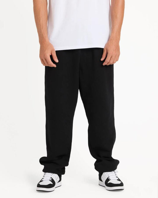 Image of a model wearing Pants. Product name - Quiksilver Mens Salt Water Trackpants Black in Black colour by brand - Quiksilver