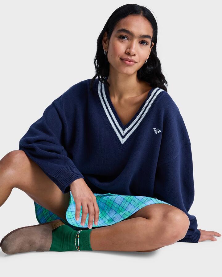 Image of a model wearing Outerwear. Product name - Roxy Womens Surf School V Neck Jumper Mood Indigo in Mood Indigo colour by brand - Roxy