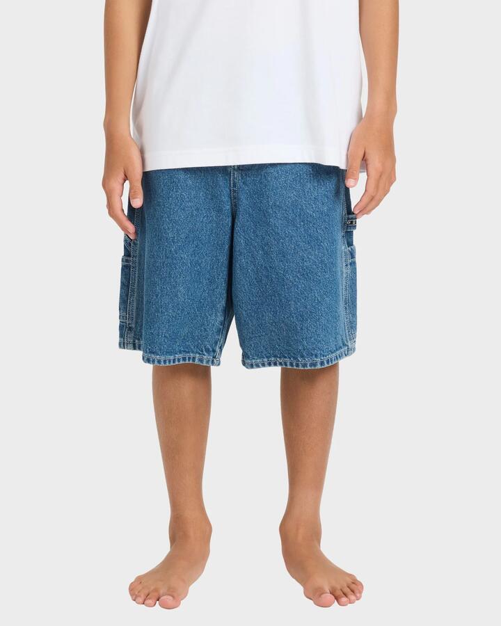 Image of a model wearing Shorts. Product name - Billabong Boys 8-16 Bad Dog 21" Walkshorts Ocean Wash in Ocean Wash colour by brand - Billabong