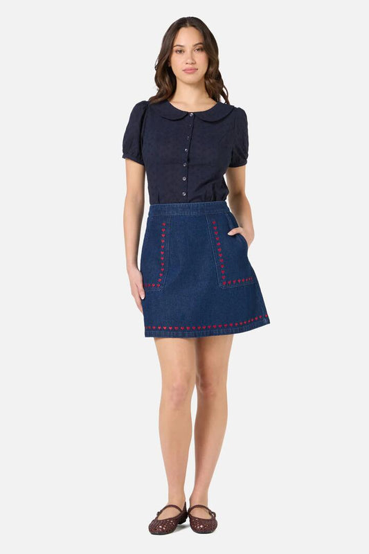 Image of a model wearing Skirts. Product name - Sweet Heart Embroidered Denim Skirt in Blue Denim colour by brand - Princess Highway