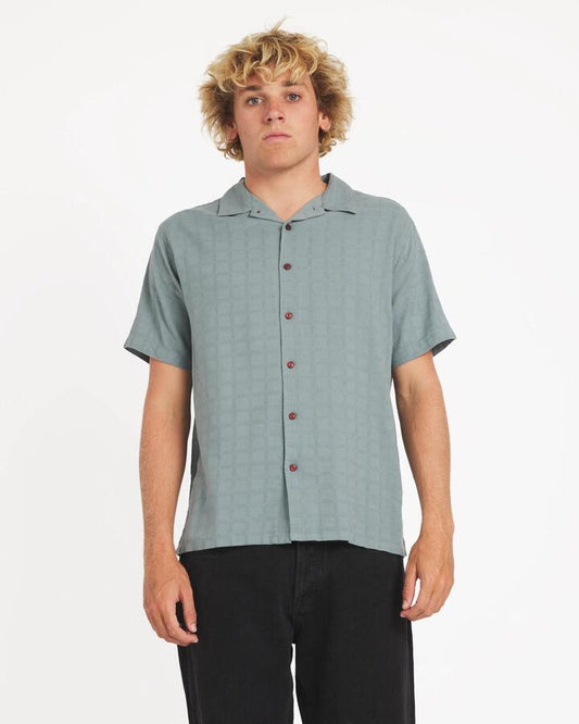 Image of a model wearing Tops. Productname: rvca - Mens Vacancy Short Sleeve Shirt - Lead - in Lead colour by brand - rvca