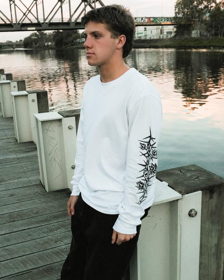 Image of a model wearing Tops. Product name - Volcom Mens Die By The Stone Long Sleeve Tee White in White colour by brand - Volcom
