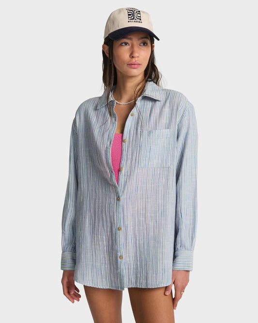 Image of a model wearing Tops. Product name - Billabong Womens Wanderer Printed Long Sleeve Button-Down Shirt Twilight Blue in Twilight Blue colour by brand - Billabong