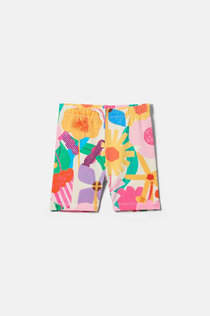 Image of a model wearing Pants. Product name - Cut Paste Floral Kids Bike Shorts in Cream colour by brand - Gorman