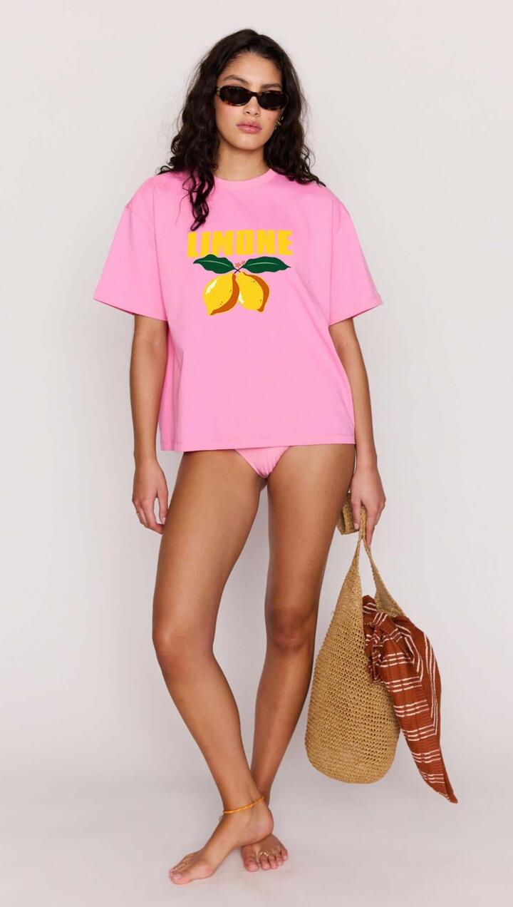 Image of a model wearing Tops. Product name - Pink Citrus Print Relaxed Oversized Cotton Tee in Pink/Yellow colour by brand - MINKPINK