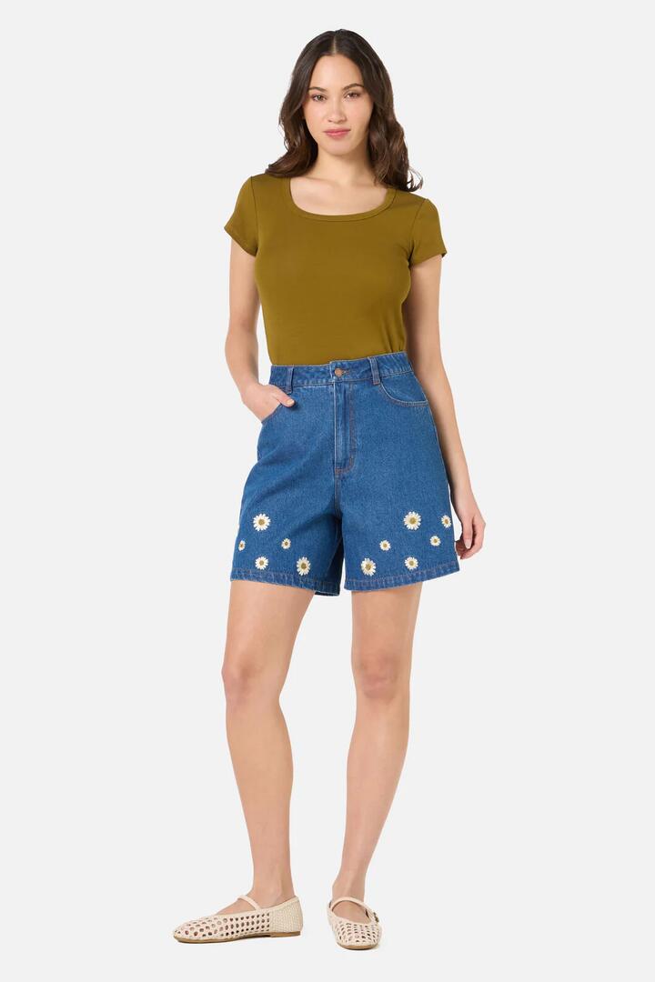 Image of a model wearing Shorts. Product name - Daria Denim Short in Blue Denim colour by brand - Princess Highway