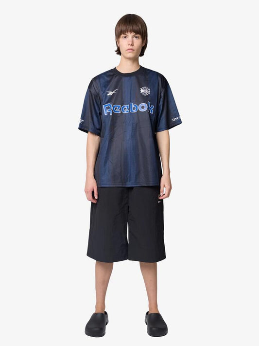 Image of a model wearing Tops. Productname: Reebok Women's Sport Jersey in Navy colour by brand - Reebok