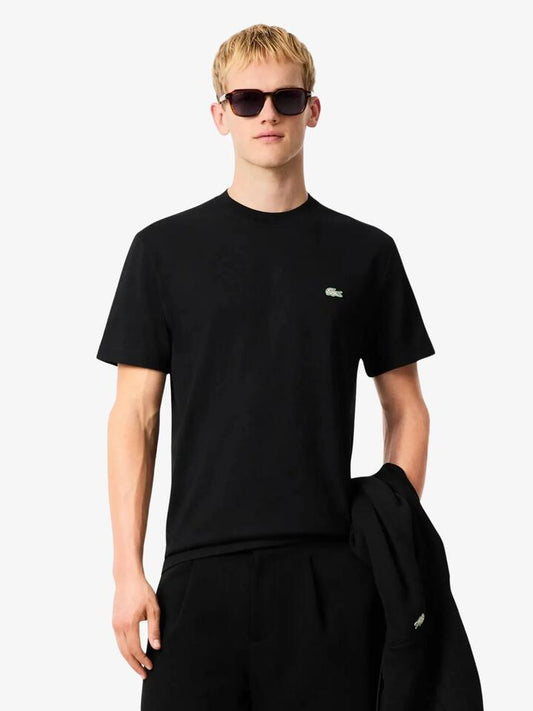 Image of a model wearing Tops. Productname: Lacoste Welcome Tennis Court Graphic T-Shirt in Black colour by brand - Lacoste
