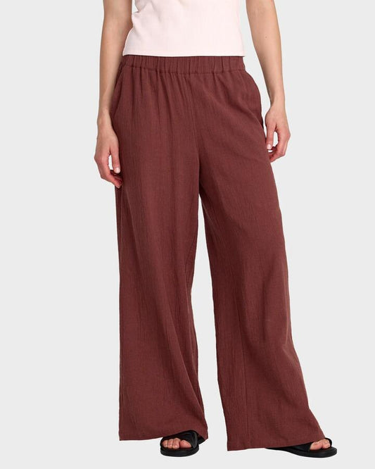 Image of a model wearing Pants. Productname: rvca - Womens New Yume Wide Pants - Terra Brown - in Terra Brown colour by brand - rvca