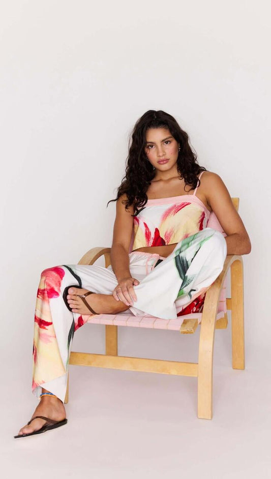Image of a model wearing Pants. Product name - Macro Floral Print Drawstring Pants in Painterly Floral colour by brand - MINKPINK