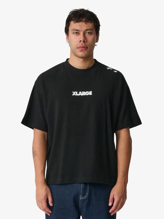 Image of a model wearing Tops. Productname: Xlarge Stars Gorilla Fit Tee in Black colour by brand - Xlarge