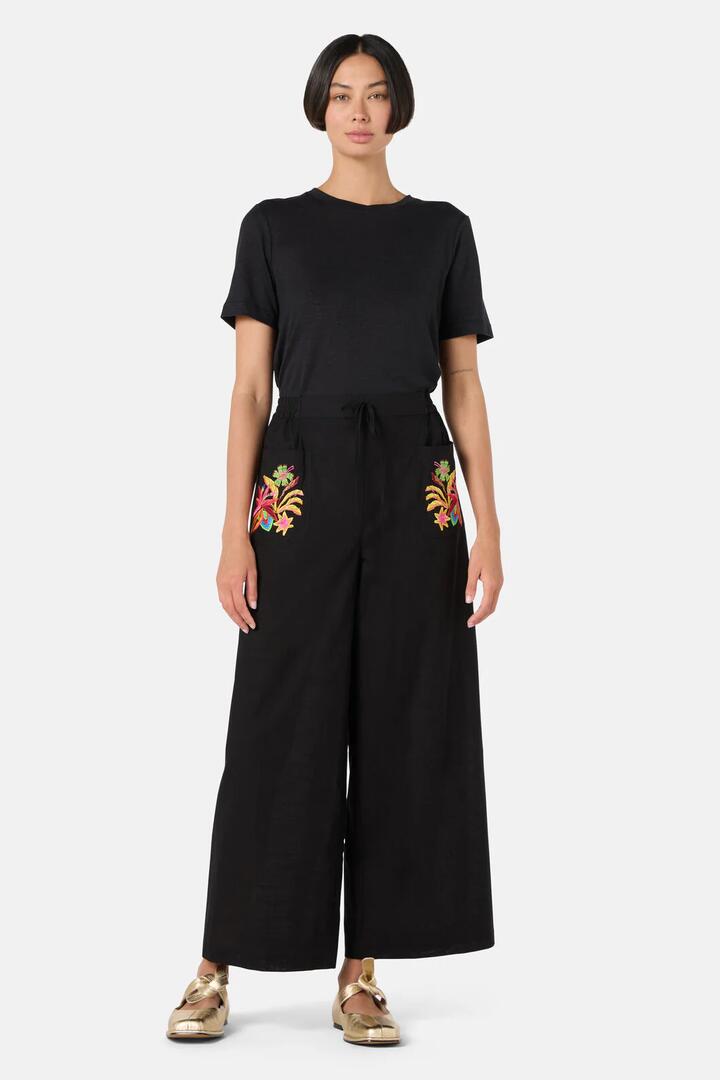 Image of a model wearing Pants. Product name - Papaya Patch Pant in Black colour by brand - Gorman