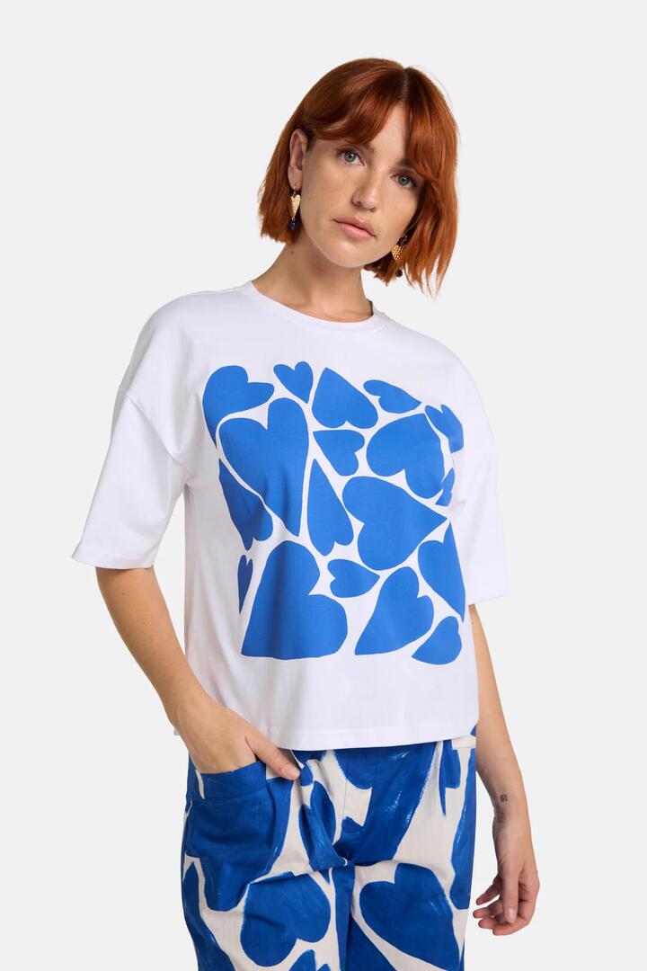 Image of a model wearing Tops. Productname: Heartbeat Placement Relaxed Tee in White colour by brand - Gorman