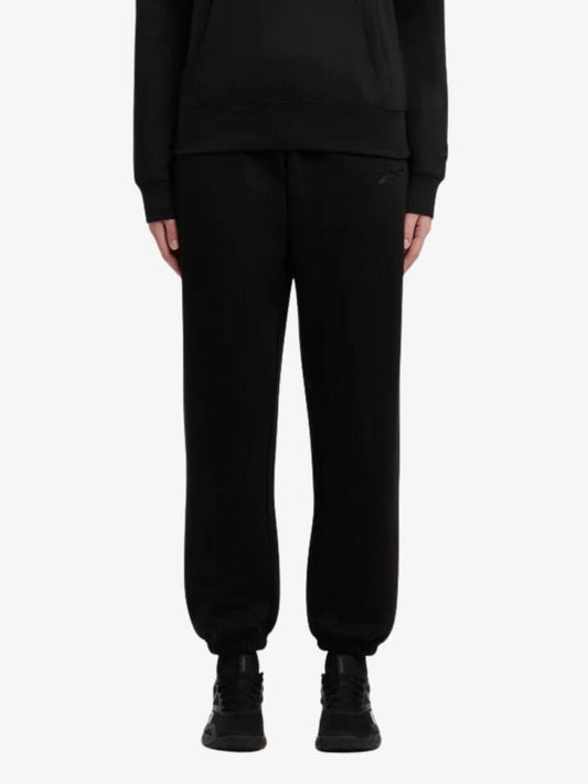 Image of a model wearing Outerwear. Productname: Reebok Satin Logo Fleece Pants in Black colour by brand - Reebok