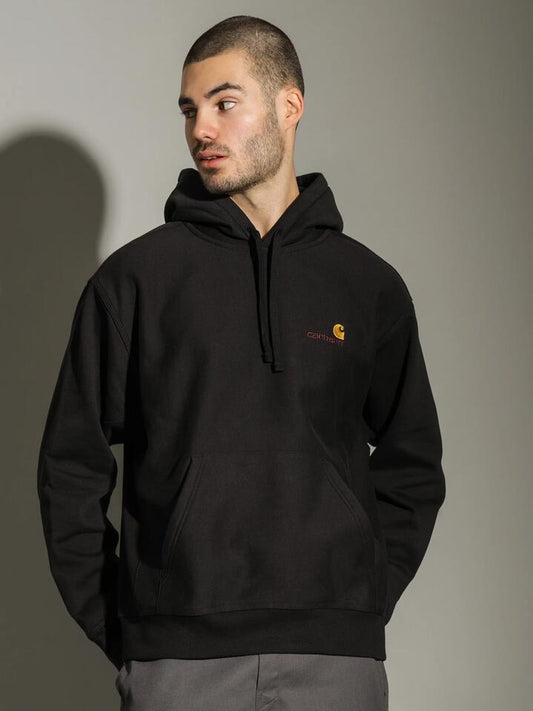 Image of a model wearing Outerwear. Productname: Carhartt Wip American Script Hoodie in Black colour by brand - Carhartt Wip