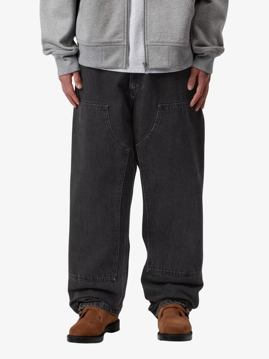 Image of a model wearing Pants. Productname: Carhartt Wip Double Knee Pants in Black Stone Washed colour by brand - Carhartt Wip