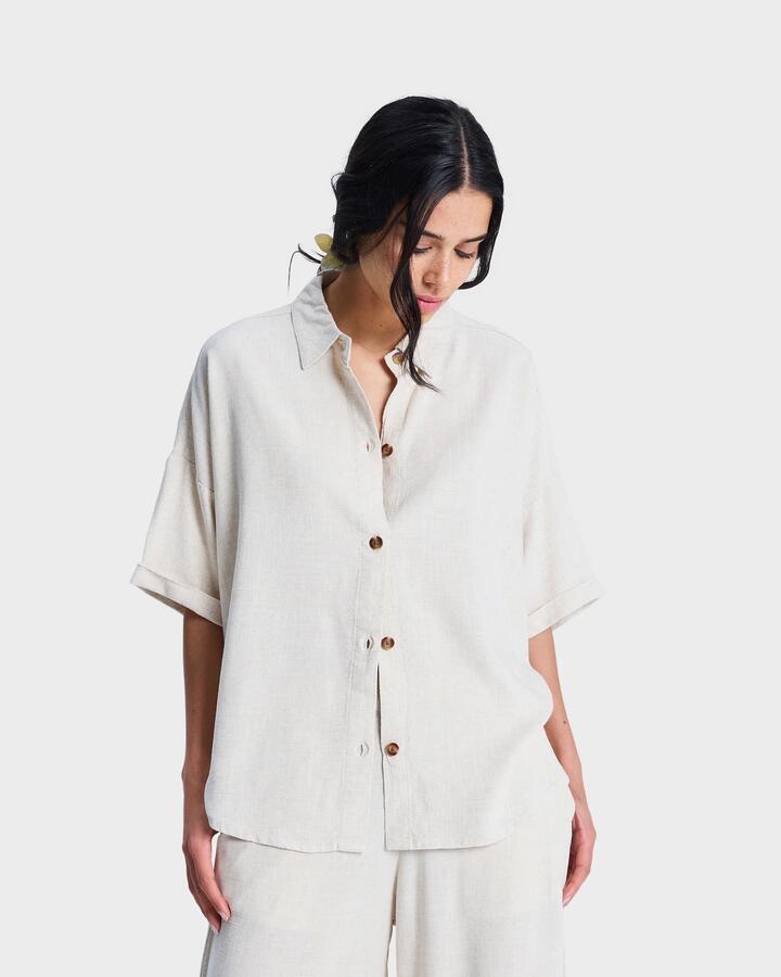 Image of a model wearing Tops. Productname: roxy Womens Beachy Short Sleeve Shirt Natural - in Natural colour by brand - Roxy