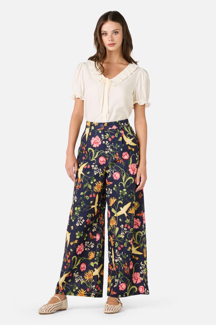 Image of a model wearing Pants. Productname: Whimsical Garden Pant in Navy colour by brand - Princess Highway