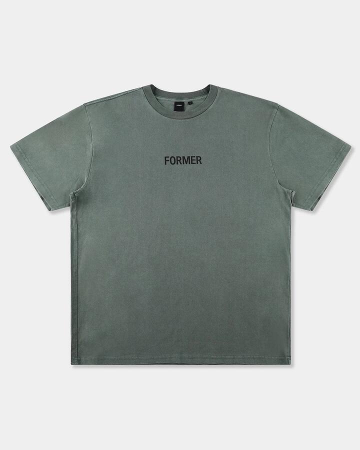 Image of a model wearing Tops. Productname: former Mens Legacy Overdye T-Shirt Pine - in Pine colour by brand - Former